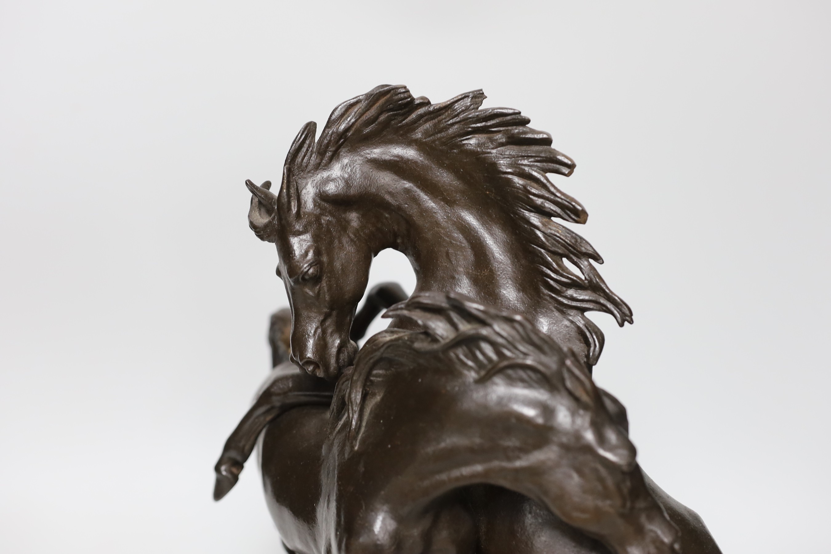 A bronzed cast iron horse group, 35cms high